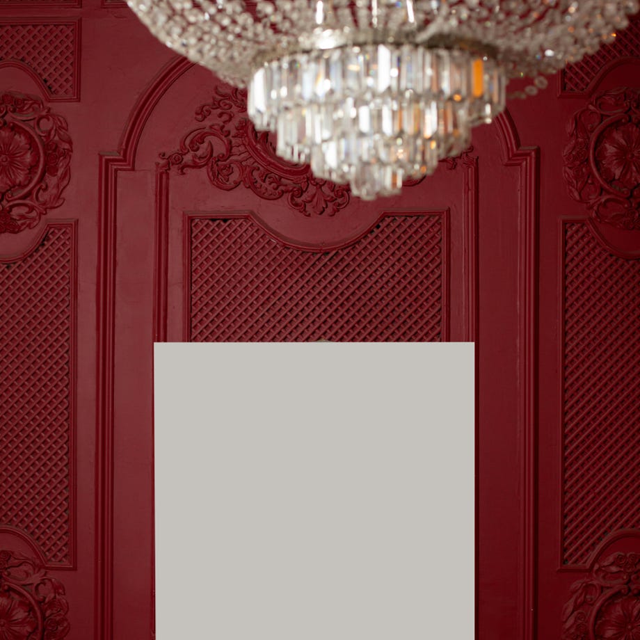White canvas on ornamental wall near chandelier in room